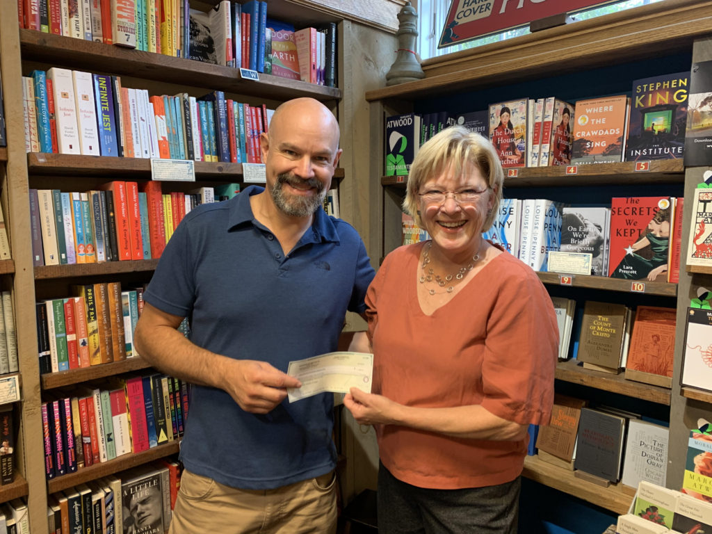 Chris Morrow gives check to Margaret Donovan