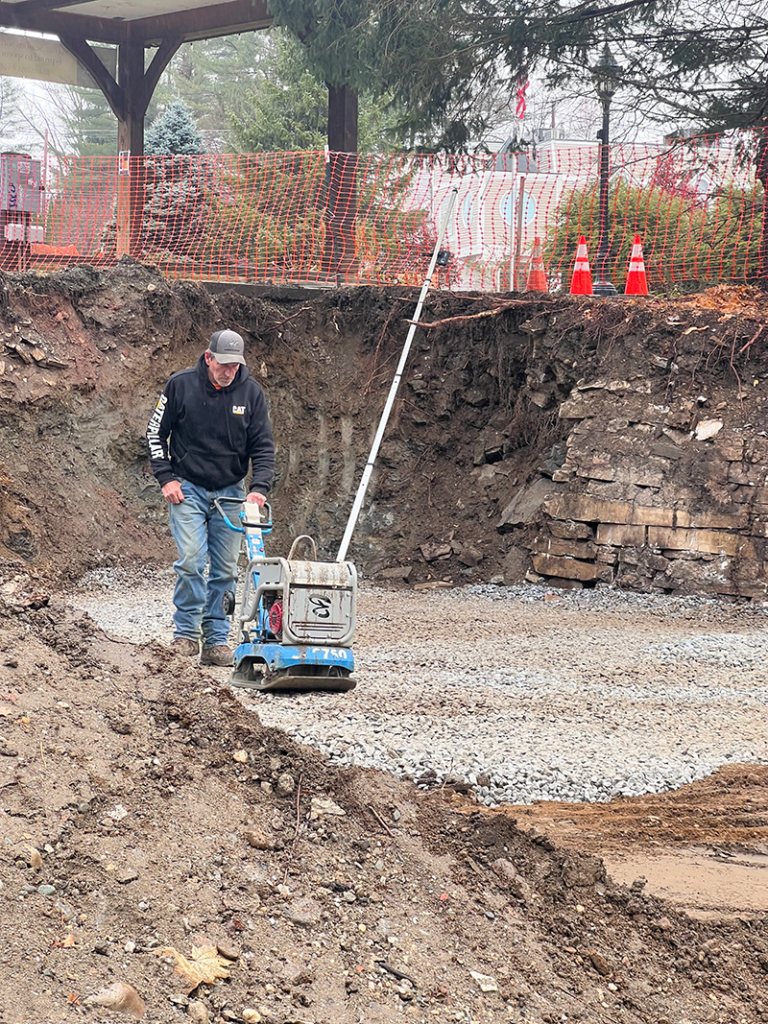 Tamping gravel in prep for the concrete abutment. 