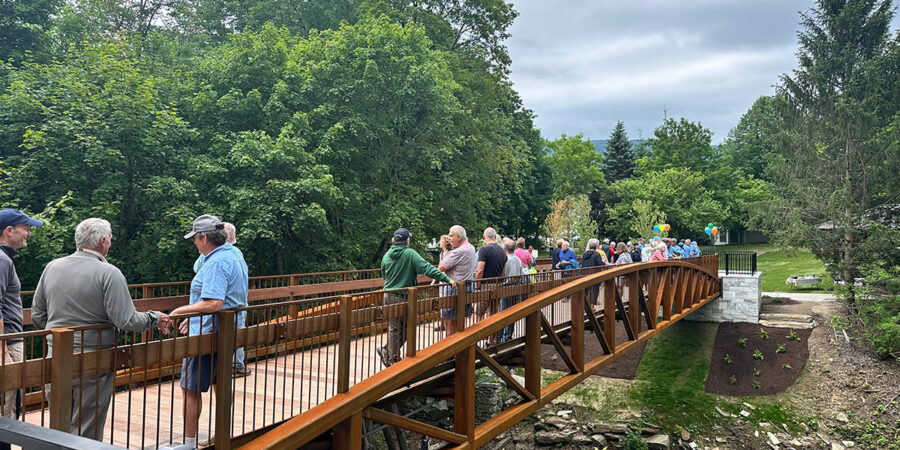 Manchester Riverwalk Bridge opening day shows lots of people enjoying it.