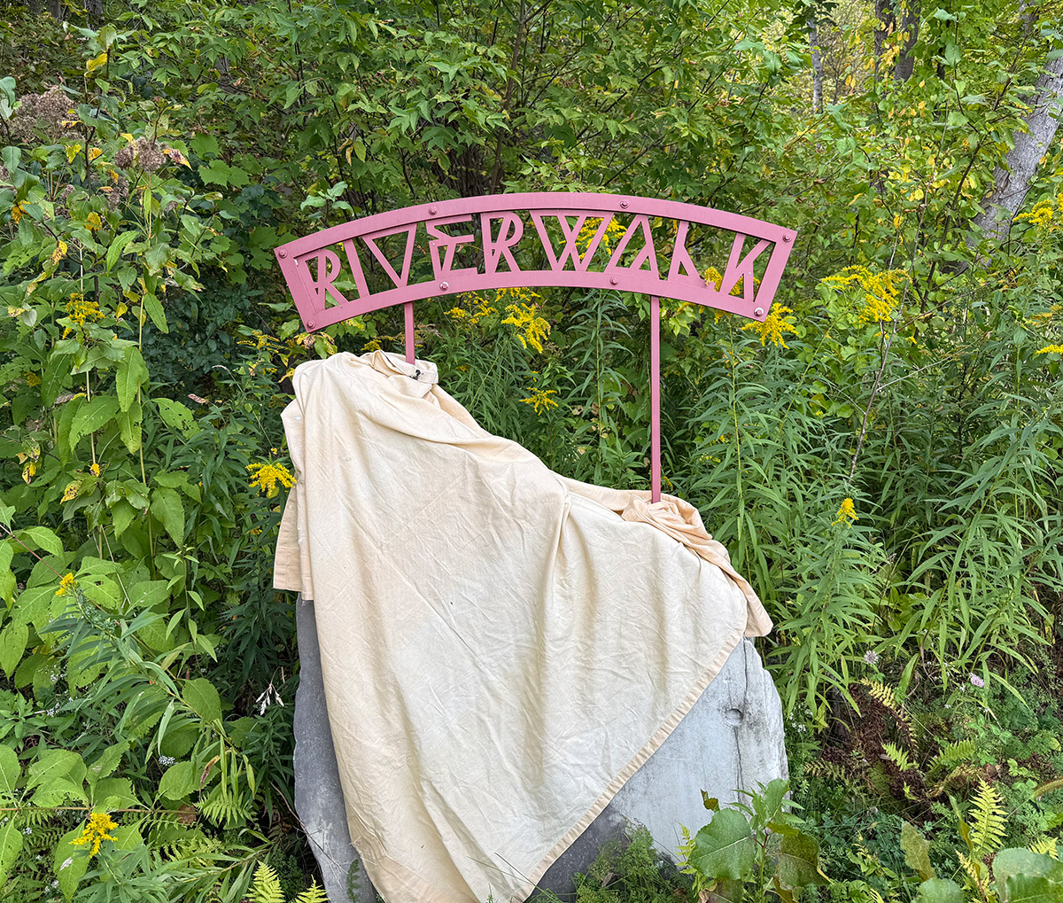 Manchester Riverwalk sign before repainting