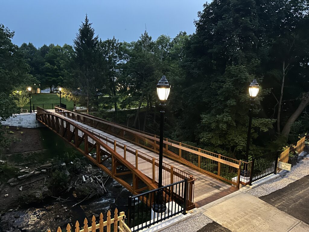 The Manchester Riverwalk Bridge with evening lights on.